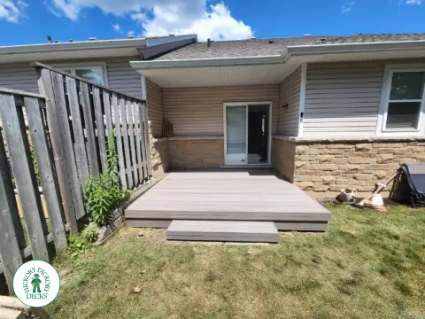 Small Trex deck with two steps down to backyard.
