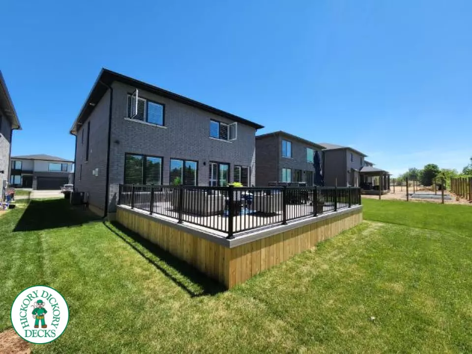 Large grey fiberon walk out deck with black aluminum railings
