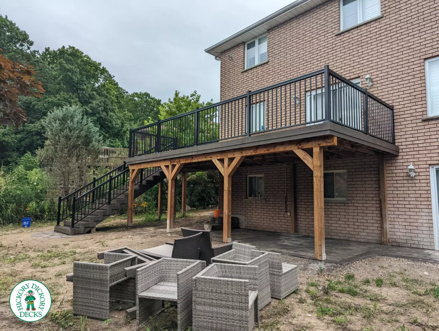High clubhouse deck with stairs leading up to top, and black aluminum railing.