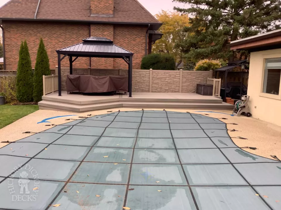 Grey pool deck with curved steps.