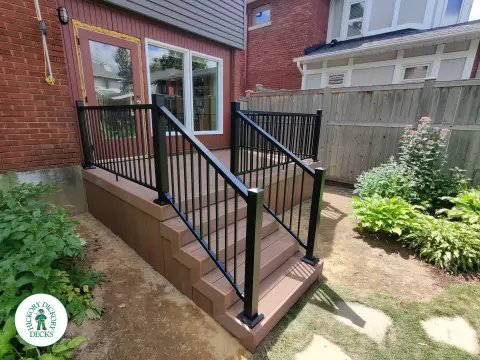 Small brown fiberon deck with black aluminum railing.