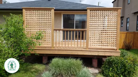 Small pressure treated deck with pressure treated privacy screens and railing.