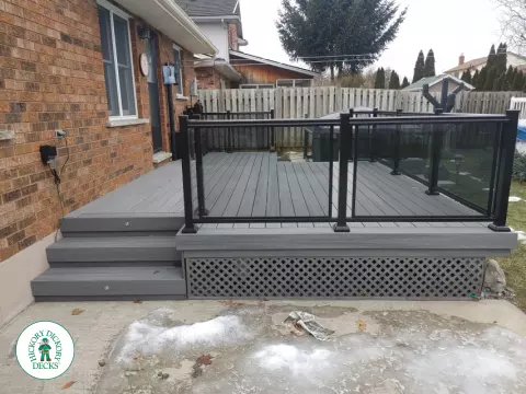 Fiberon low deck with glass railings in Welland
