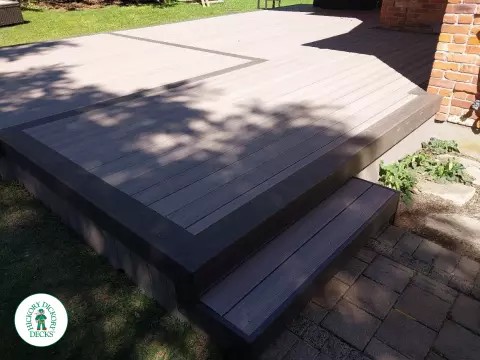 Grey deck with dark grey trim and a sunspace roof structure.