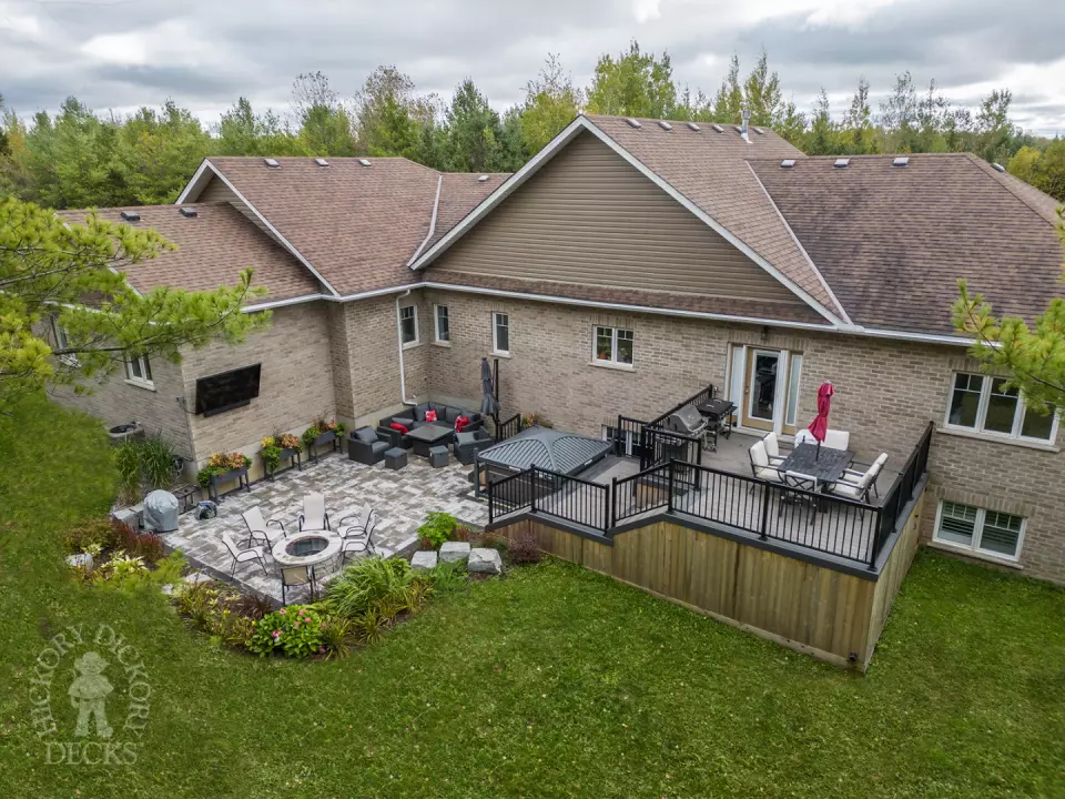 2 level clubhouse deck with cedar skirting, black aluminum railing, and grey color with darker grey border.