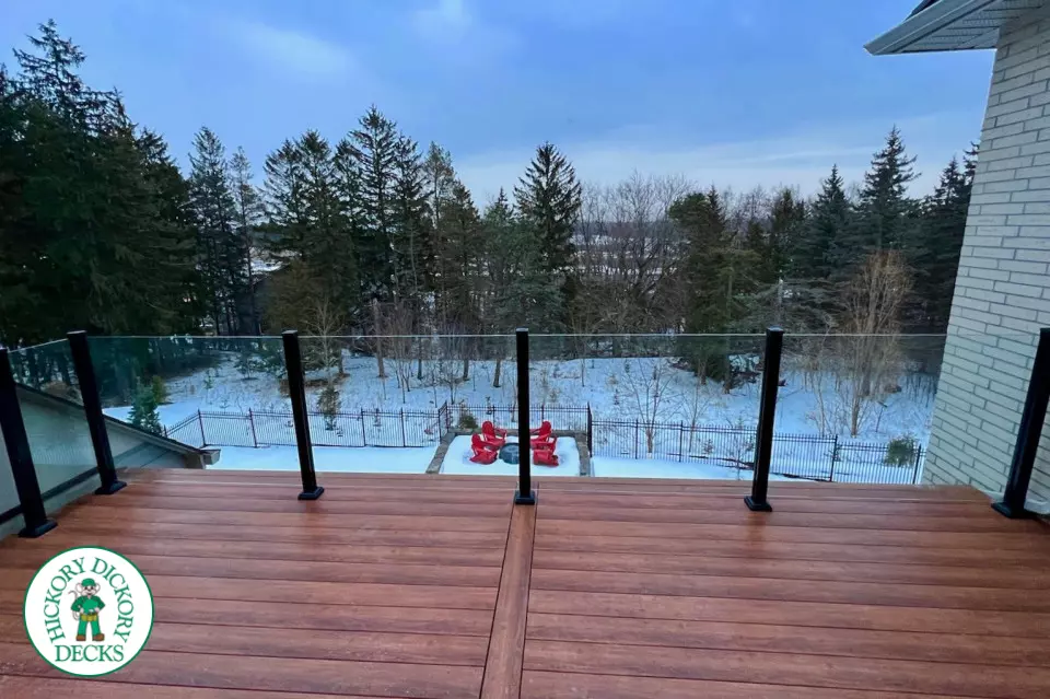 High brown composite deck with glass railings