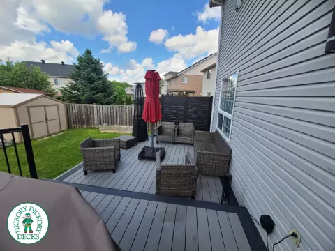 Trex deck in grey color with wrap around stairs, lights in steps.
