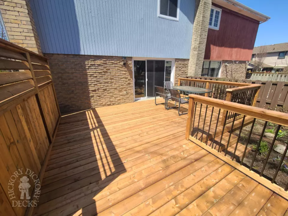 Low cedar deck with picket cedar railings and a cedar privacy screen.