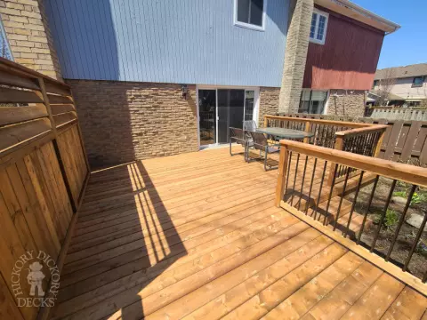 Low cedar deck with picket cedar railings and a cedar privacy screen.