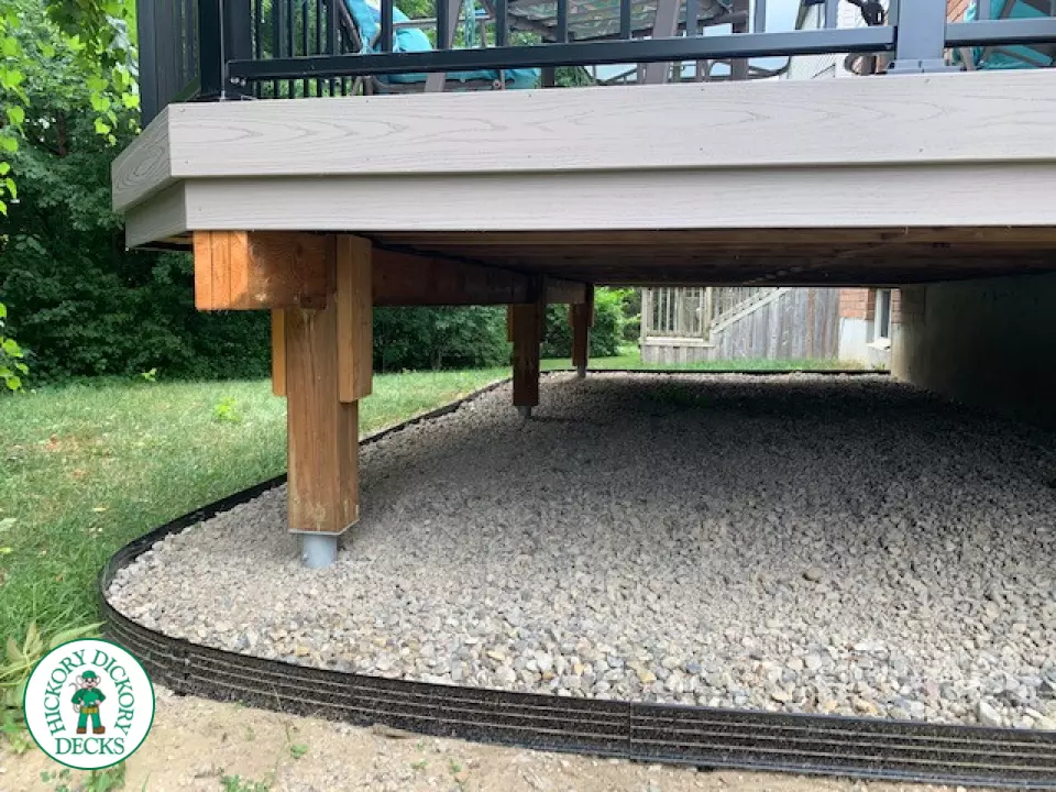 Mid size elevated deck built in grey composite with black railing.