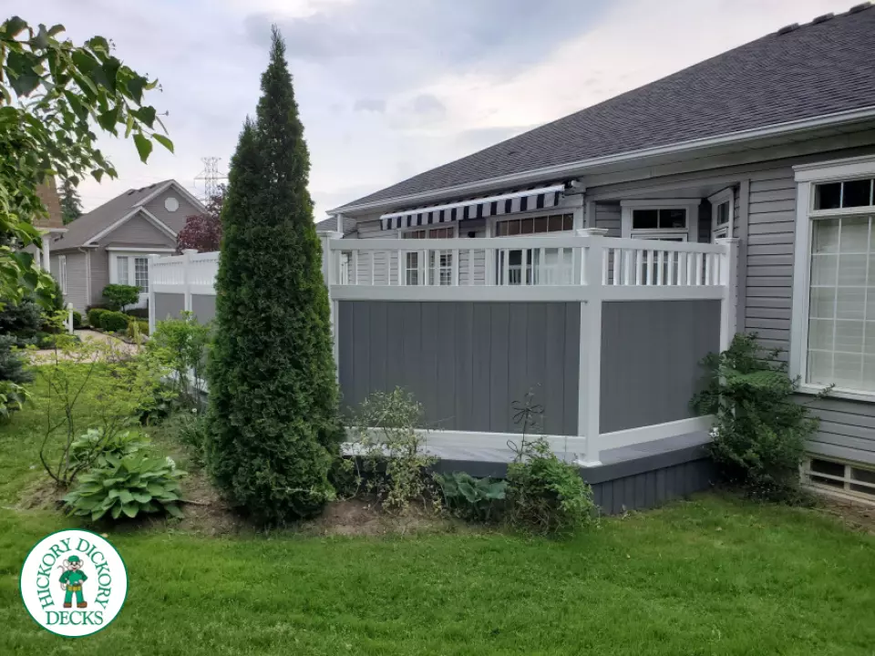 Private grey walk out deck with grey privacy screen all around