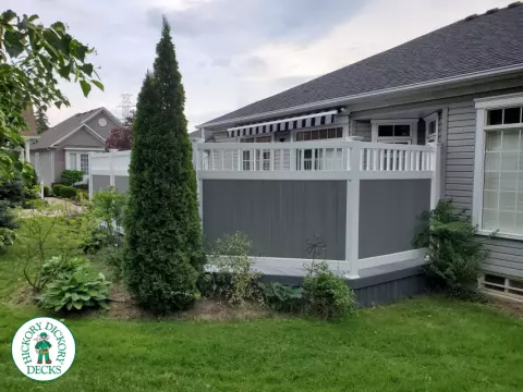 Private grey walk out deck with grey privacy screen all around