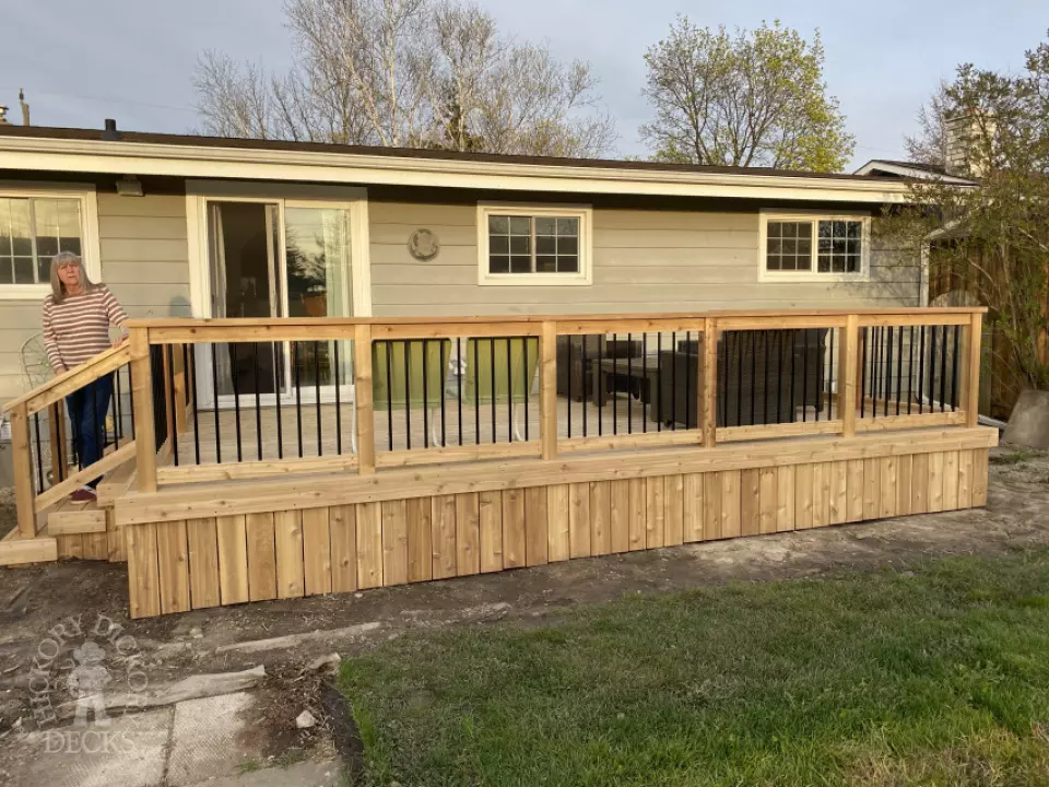 mid size walkout cedar deck with cedar picket railing