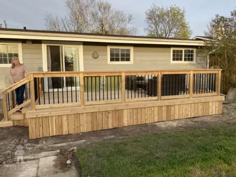 mid size walkout cedar deck with cedar picket railing