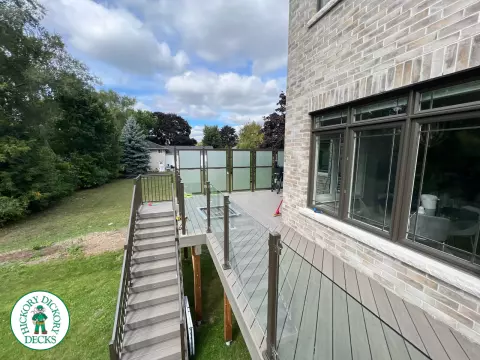 High grey composite deck with glass style railings.