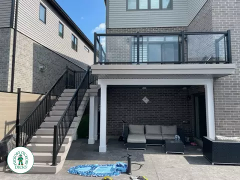High grey composite deck with glass style railings.