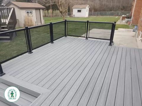Fiberon low deck with glass railings in Welland