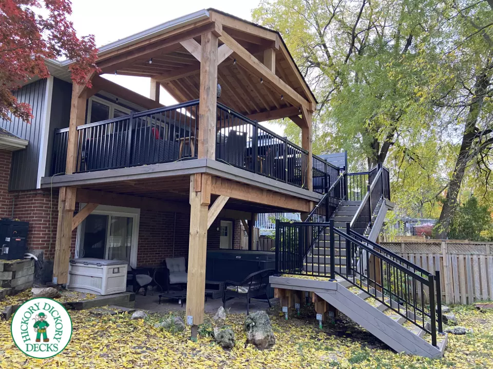 Mid-high deck brown TruNorth deck with lighting in steps and black aluminum railing all around.