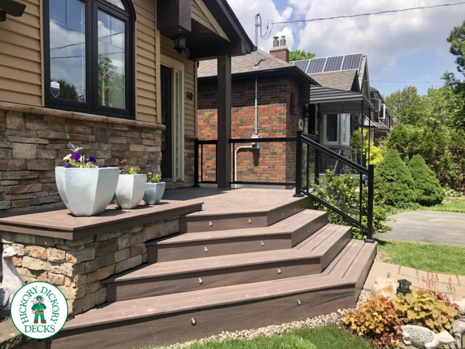 Brown porch with angled steps with lighting.