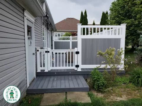 Private grey walk out deck with grey privacy screen all around