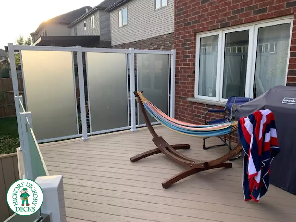 Large high Azek deck with frosted glass privacy screen.