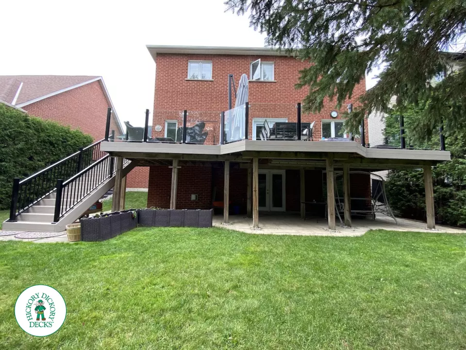 High Deck with stairs in Clay composite with glass railings.