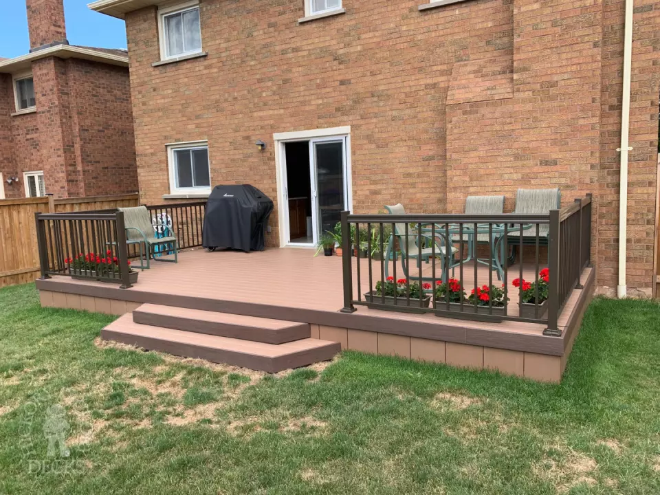 Small brown veka deck with two steps and aluminum railing.