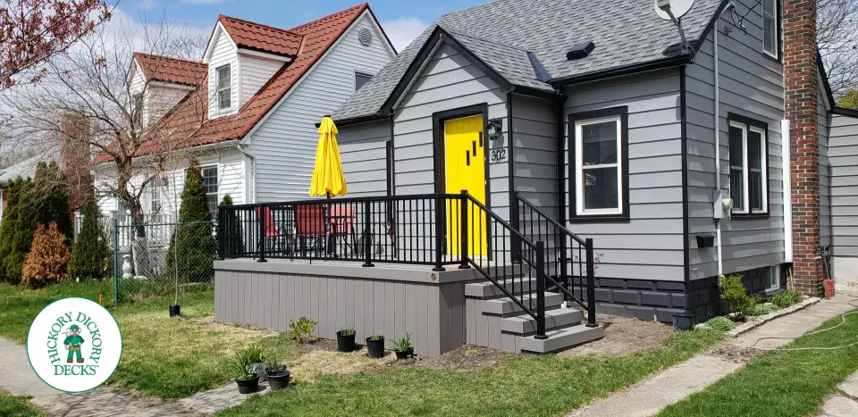 Small grey composite deck with black aluminum railing