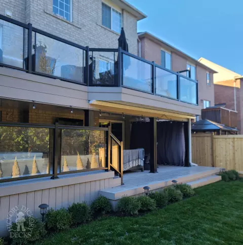 Azek high deck with glass railings and spiral stairs in Brampton