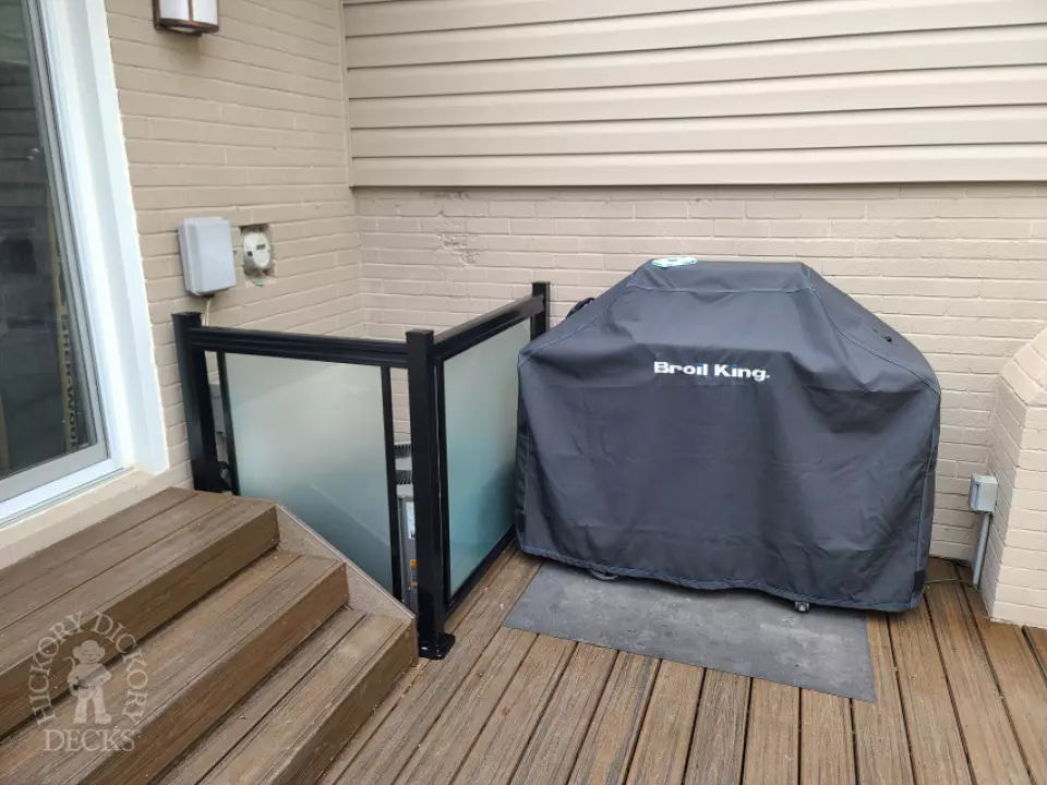 Large brown composite deck with pergola and unique stairs.