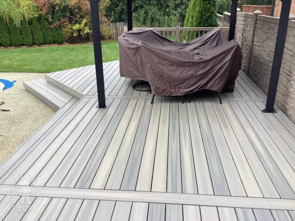 Grey pool deck with curved steps.