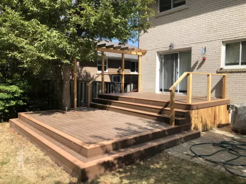 TruNorth deck with Mocha Caramel trim, wraparound steps, lights and a pergola, built around a tree. Etobicoke, Ontario