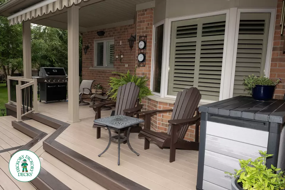 221 square foot light brown deck with dark brown border. This deck has curved steps and glass railings.