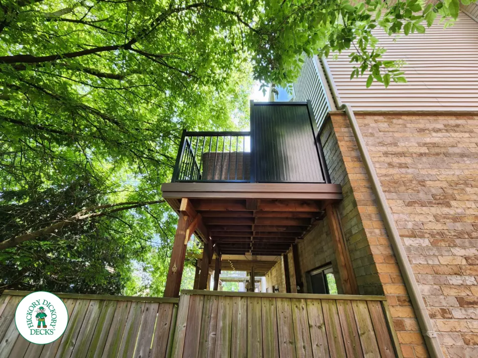 High brown Armadillo balcony with black aluminum railing.