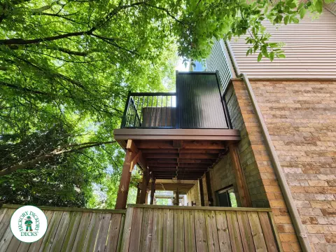 High brown Armadillo balcony with black aluminum railing.