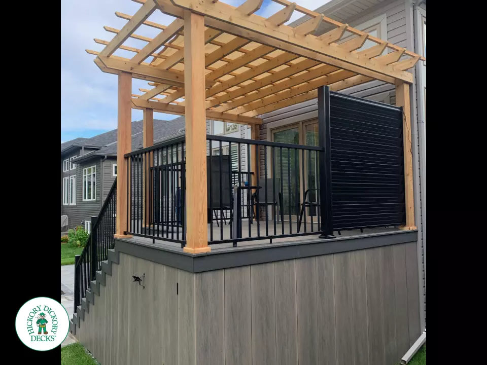 Mid high clubhouse deck with cedar pergola and a dark grey border.