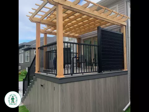 Mid high clubhouse deck with cedar pergola and a dark grey border.