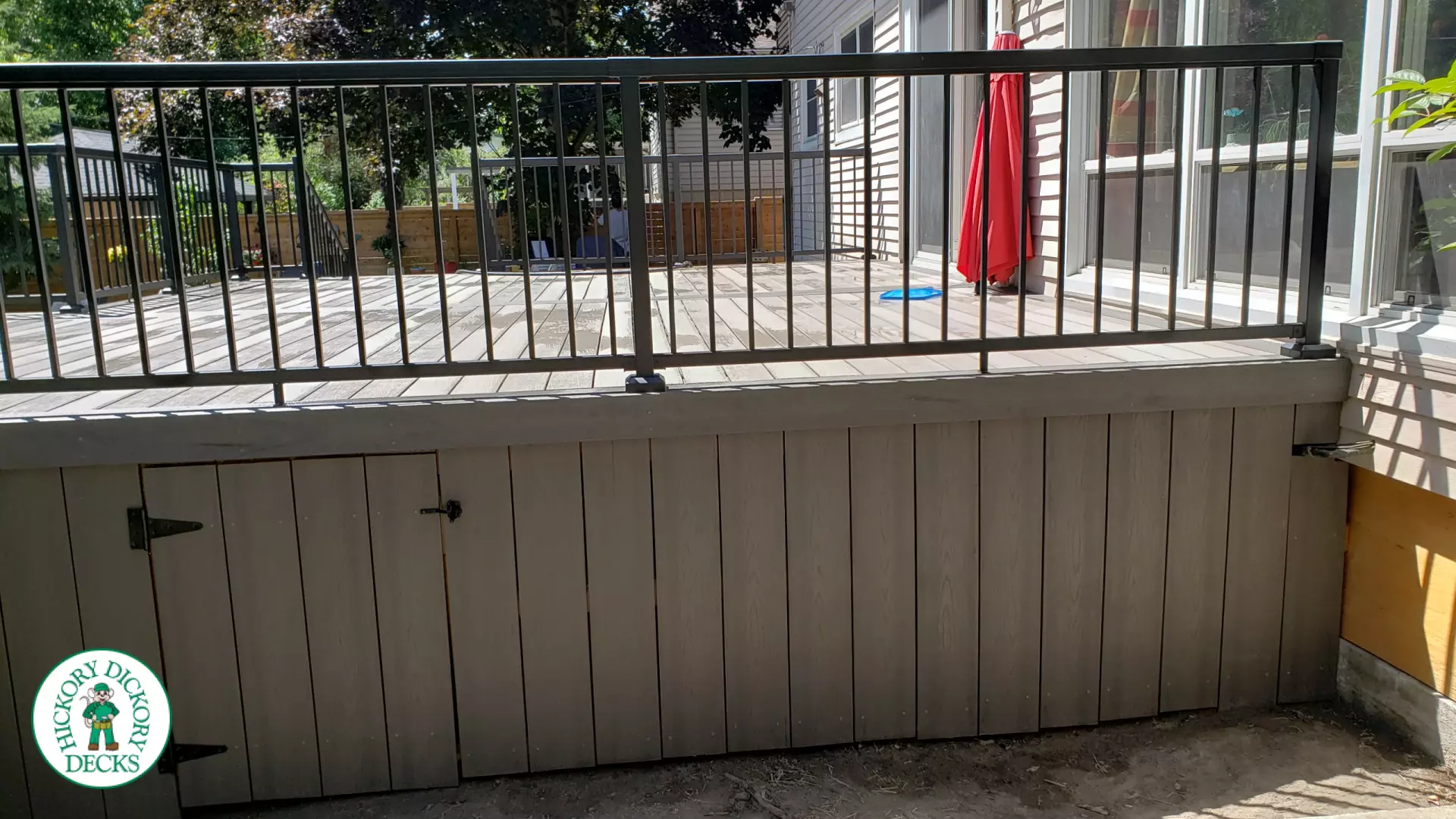 Grey above ground pool deck with black aluminum railings