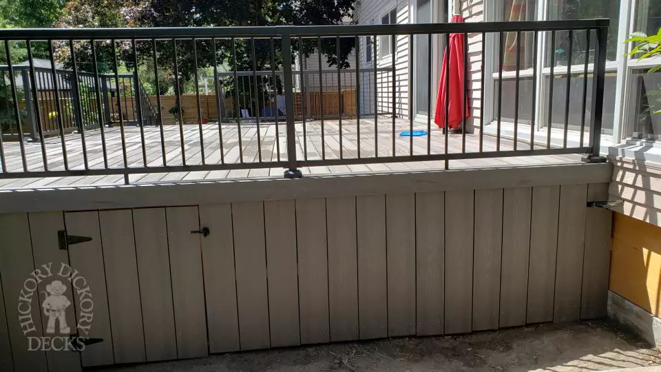 Grey above ground pool deck with black aluminum railings