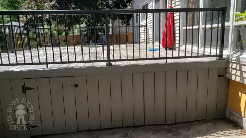 Grey above ground pool deck with black aluminum railings