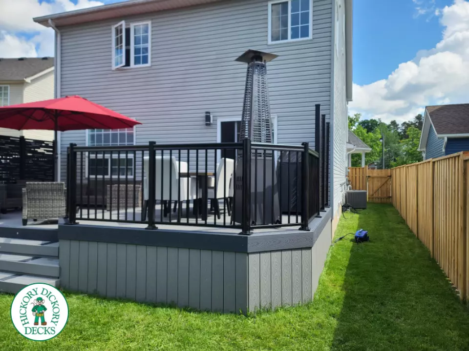 Trex deck in grey color with wrap around stairs, lights in steps.