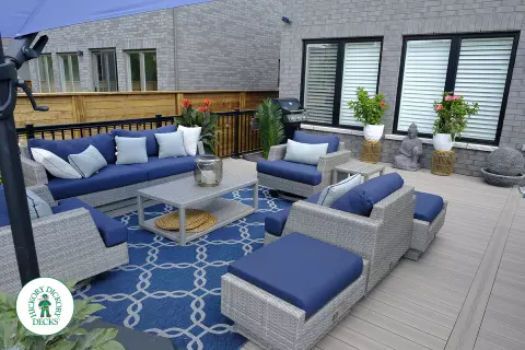 Large grey Fiberon walk out deck with black aluminum railings in Ancaster