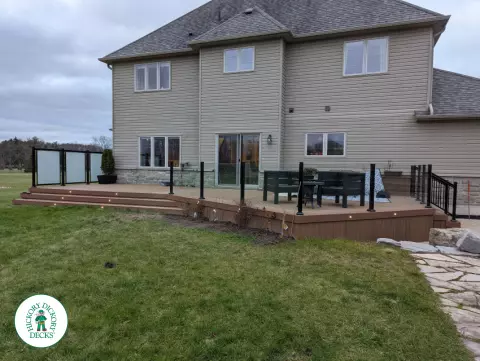 Fiberon deck with glass railings, privacy screens and lights in Brantford
