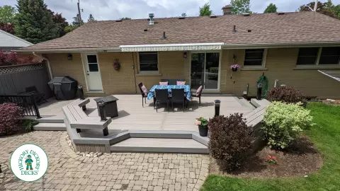 Low to ground grey deck with custom benches