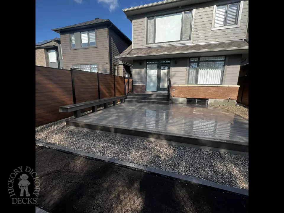 Grey Clubhouse deck with dark grey border, lighting in steps, and a custom bench.