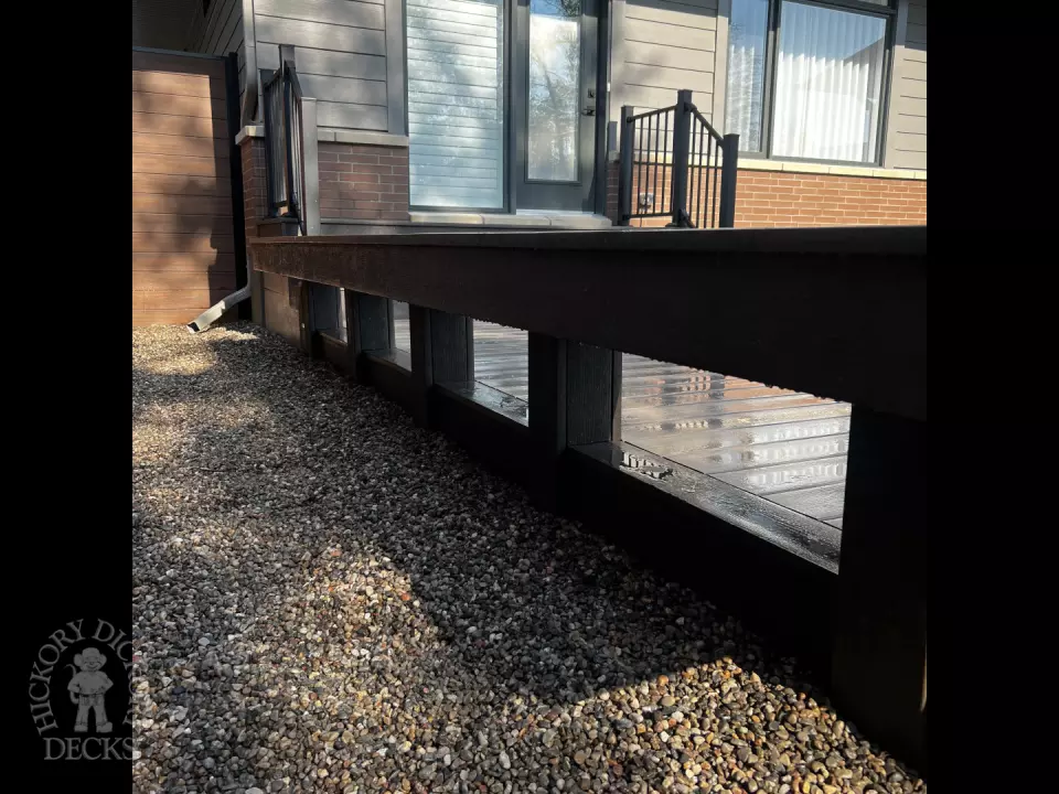 Grey Clubhouse deck with dark grey border, lighting in steps, and a custom bench.