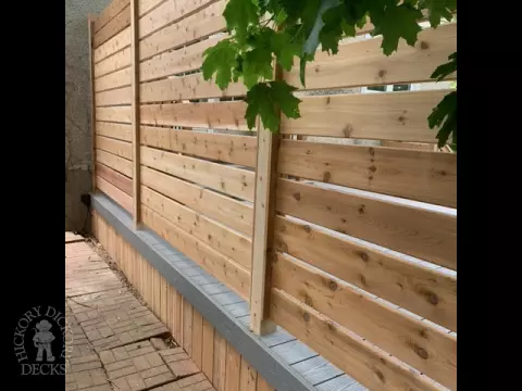 Grey fiberon deck with cedar railing and a cedar privacy screen.