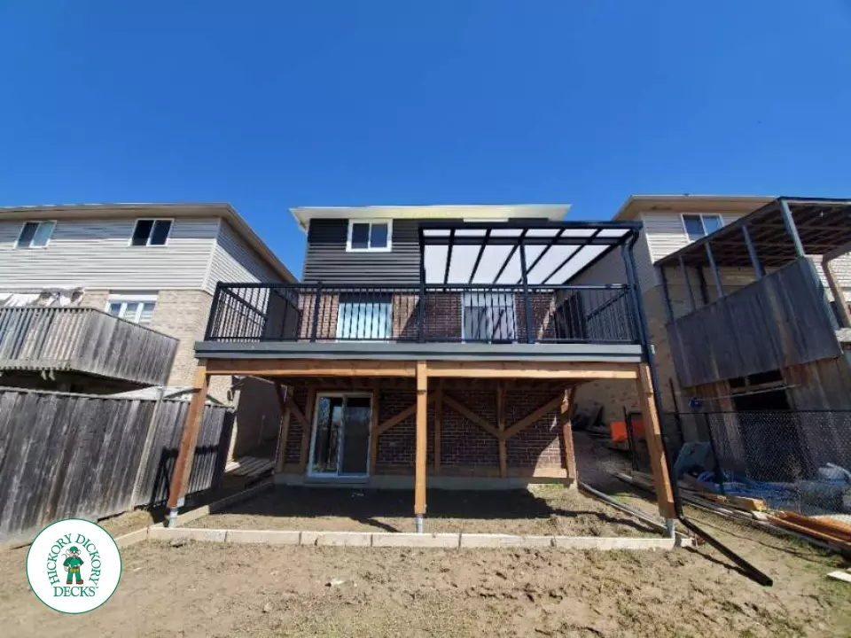 Trex deck with privacy screens and custom roof in Ancaster