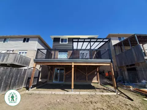 Trex deck with privacy screens and custom roof in Ancaster