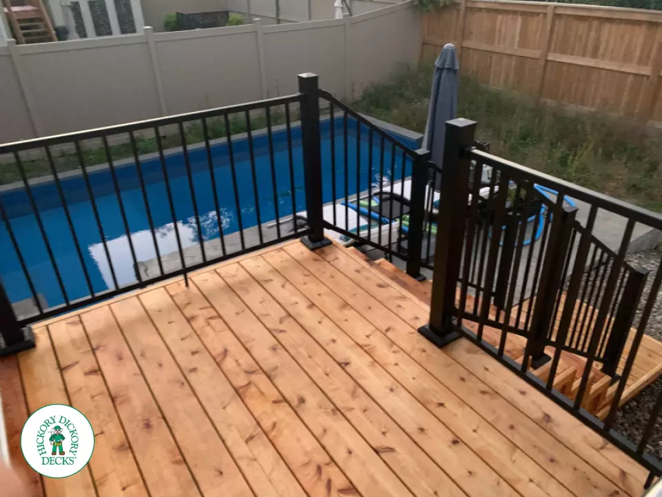 Small Poolside Cedar Deck with Stairs with Lights in Ottawa